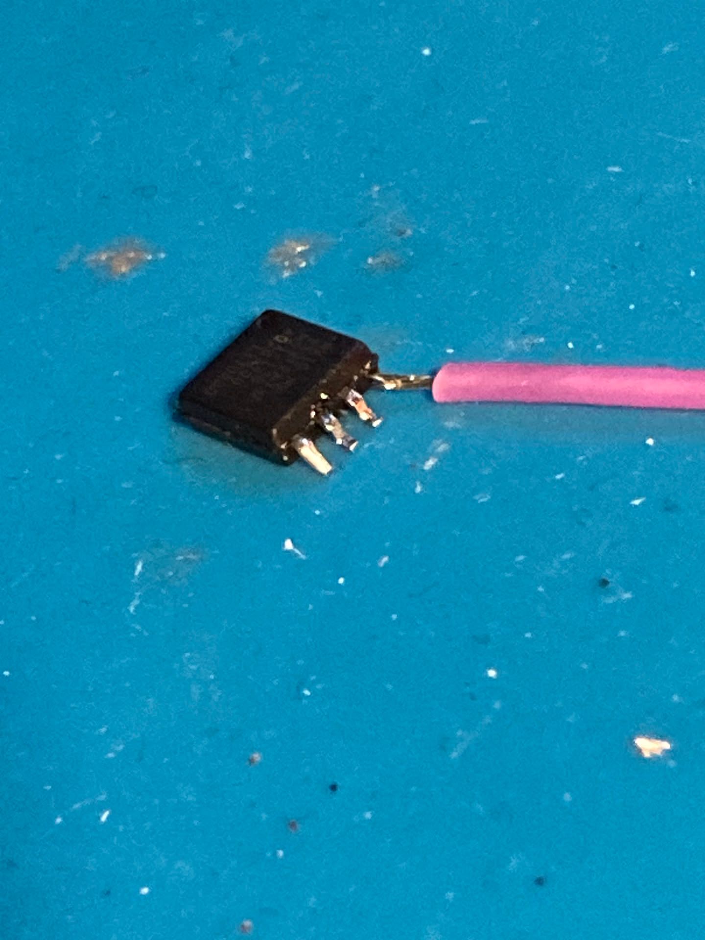 Trying to solder a wire to the chip's broken leg